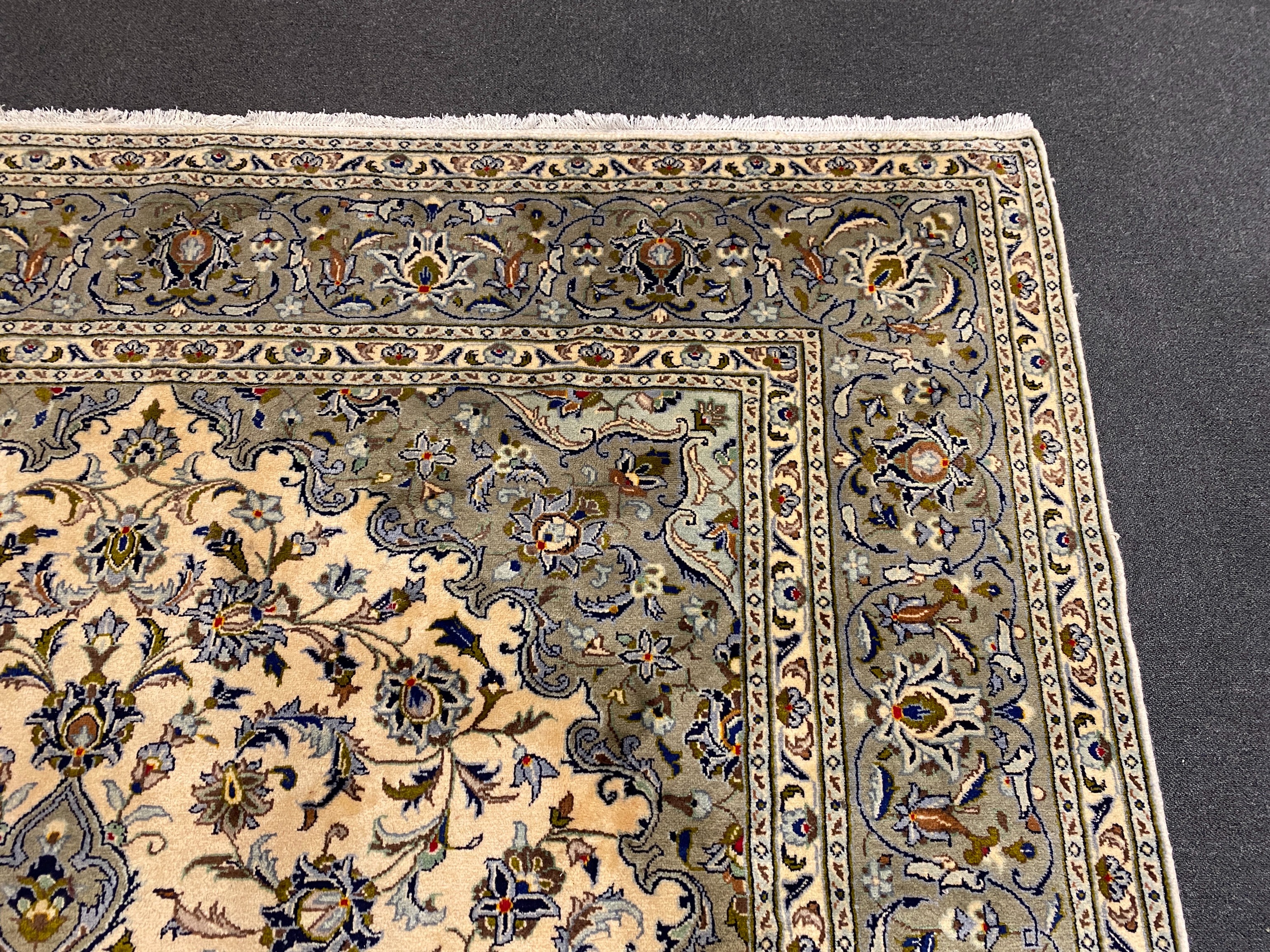 A Kashan ivory ground carpet, 355cm x 246cm